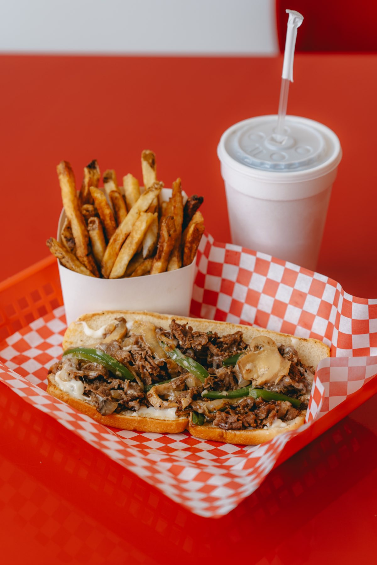 A Dog Et Al meal — Philly cheesesteak with hand-cut fries and a drink