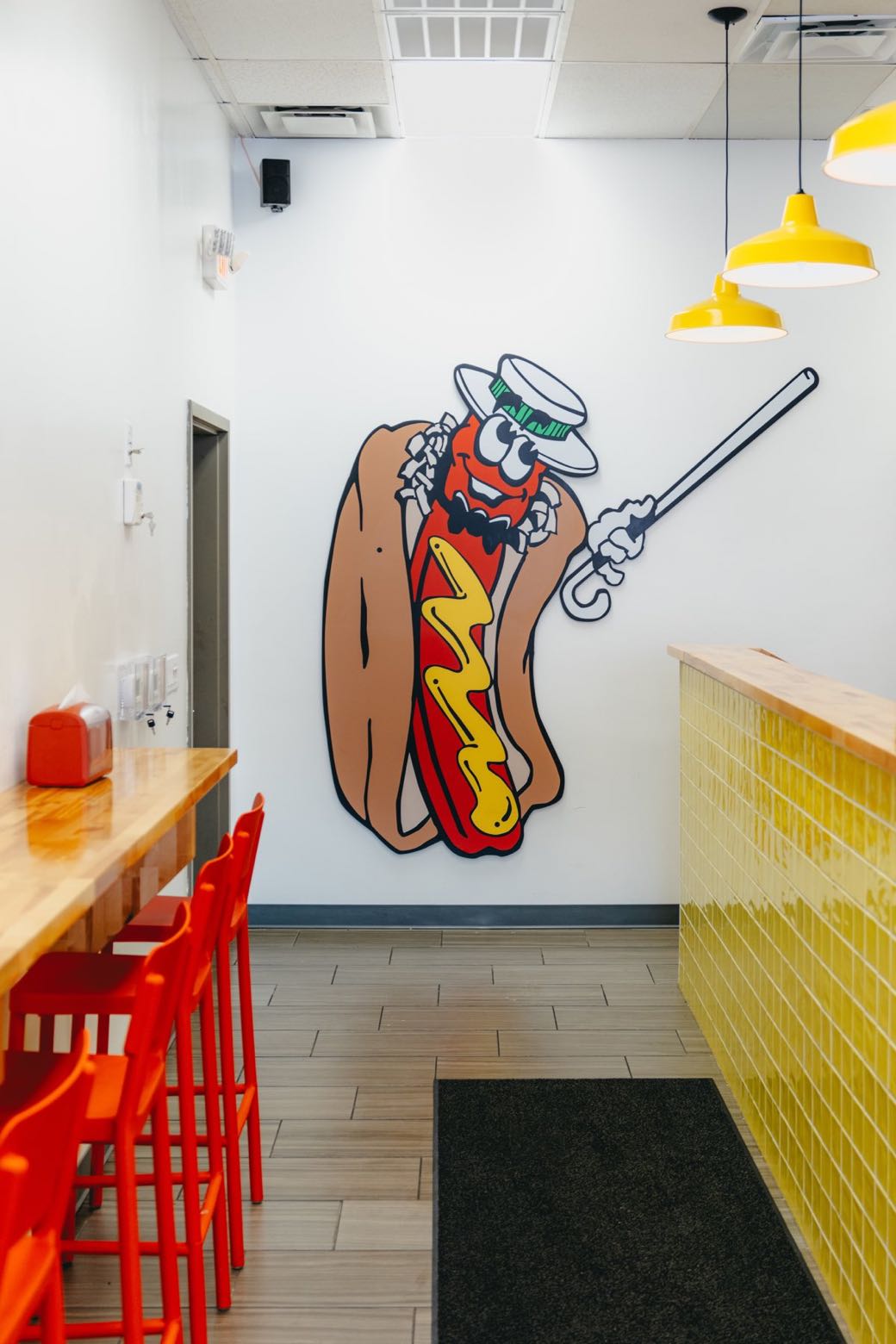 The Dog Et Al hot dog mascot mural on the restaurant wall